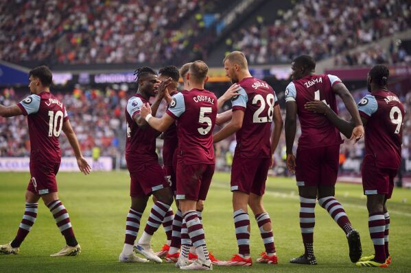 West Ham United's Tomas Soucek, third from right, celebrates scoring their side's second goal of the game with team-mates during the English Premier League soccer between West Ham United and Luton Town match at the London Stadium, London, Saturday May 11, 2024. (Victoria Jones/PA via AP)