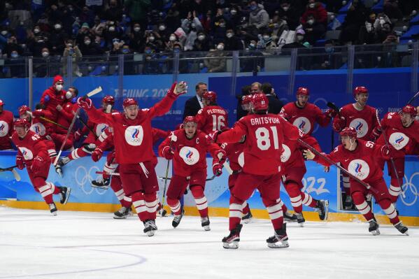 The Russian Olympic Committee celebrates the winning goal during a shootout by Arseni Gritsyuk (81) in a men's semifinal hockey game against Sweden at the 2022 Winter Olympics, Friday, Feb. 18, 2022, in Beijing. (AP Photo/Petr David Josek)