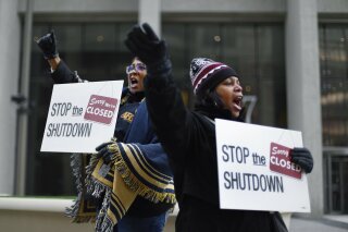 
              FILE - In this Jan. 10, 2019 file photo Cheryl Monroe, right, a Food and Drug Administration employee, and Bertrice Sanders, a Social Security Administration employee, rally to call for an end to the partial government shutdown in Detroit. The government shutdown left an especially painful toll for African-Americans who make up nearly 20 percent of the federal workforce and historically have been on the low end of the government pay scale. The U.S. Office of Personnel Management says African-Americans make up about 18 percent of the federal workforce of approximately 2.1 million employees. (AP Photo/Paul Sancya, file)
            