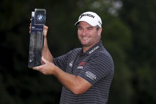 Ryan Fox of New Zealand poses with the trophy after day four of the 2023 PGA Championship at Wentworth Golf Club in Virginia Water, Surrey, England, Sunday, Sept. 17, 2023. (John Walton/PA via AP)