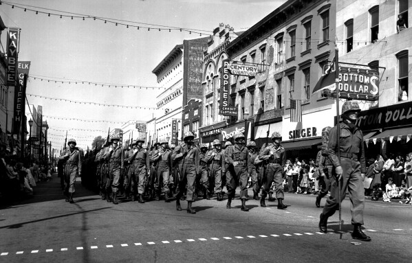 A military unit marches during the Savannah St. Patrick's Day parade, March 16, 1957. Savannah, Georgia's oldest city, is planning a supersized celebration as it marks the 200th anniversary of its beloved St. Patrick's Day parade. (Jim Bisson/Savannah Morning News via AP)