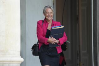 French Prime Minister Elisabeth Borne greets the media as he leaves the Elysee Palace after the cabinet meeting at the Elysee Palace, Friday, July 29, 2022. (AP Photo/Michel Euler)