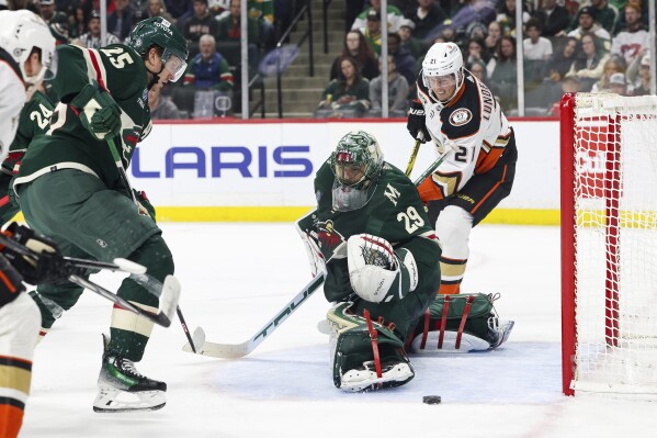 Minnesota Wild goaltender Marc-Andre Fleury (29) blocks the puck from Anaheim Ducks center Isac Lundestrom (21) during the second period of an NHL hockey game Thursday, March 14, 2024, in St. Paul, Minn. (AP Photo/Stacy Bengs)