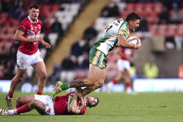 Wales' Elliot Kear tackles Cook Islands' Anthony Gelling during the Rugby League World Cup group D match between Wales and Cook Islands at Leigh Sports Village in Leigh, England, Wednesday Oct. 19, 2022. (Martin Rickett/PA via AP)