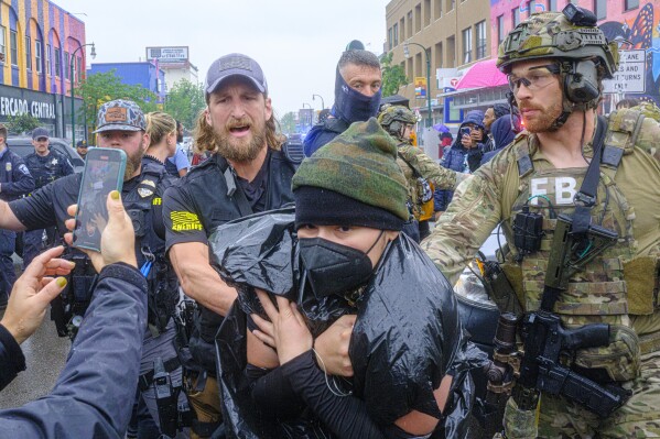 Community protesters confront law enforcement officers as federal agents conduct an operation in Minneapolis, on Tuesday, June 3, 2025. (Kerem Yücel/Minnesota Public Radio via AP)