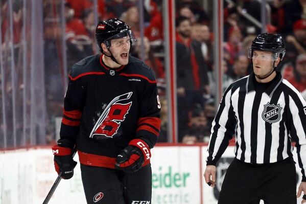 Carolina Hurricanes' Mikko Rantanen (96) protests against a penalty with an official during the third period of an NHL hockey game against the Edmonton Oilers in Raleigh, N.C., Saturday, March 1, 2025. (AP Photo/Karl DeBlaker)