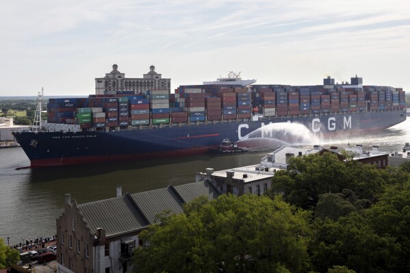 FILE - The container ship CMA CGM Marco Polo sails up river past the historic River Street in Savannah, Ga., to the Port of Savannah, Wednesday, May, 26, 2021. All of Georgia's members of Congress have signed a letter that supports studying another round of deepening the shipping channel to the Port of Savannah. (AP Photo/Stephen B. Morton, File)