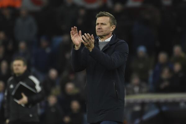 Leeds United's head coach Jesse Marsch applauds his teams traveling fans after the end of the English Premier League soccer match between Aston Villa and Leeds United at Villa Park in Birmingham, England, Friday, Jan. 13, 2023. Villa won the game 2-1. (AP Photo/Rui Vieira)