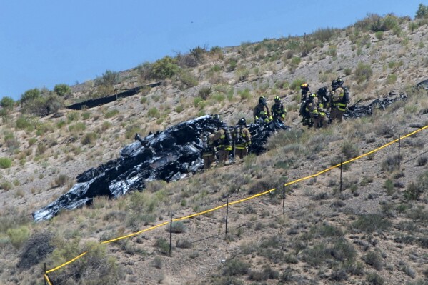 Emergency workers respond to a military plane crash near the Albuquerque International Airport, Tuesday, May 28, 2024, in Albuquerque, N.M. The pilot escaped the plane before it crashed. (Eddie Moore/The Albuquerque Journal via AP)