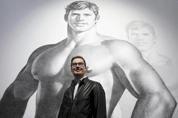 Kiasma museum director Leevi Haapala poses at the exhibition of Finnish artist Tom of Finland during the media day of his retrospective exhibition 'Bold Journey' at the Finnish National Gallery Kiasma in Helsinki, Finland, Thursday, April 27, 2023. A new exhibition showing the works of Touko Laaksonen, better known by his pseudonym Tom of Finland, adds a personal touch to the late Finnish artist whose homoerotic drawings of muscular men gained a following in the gay community starting in the 1950s. (Vesa Moilanen/Lehtikuva via AP)