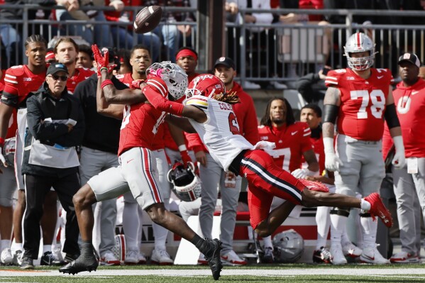 Ohio State receiver Marvin Harrison, left, makes a catch against Maryland defensive back Corey Coley during the second half of an NCAA college football game Saturday, Oct. 7, 2023, in Columbus, Ohio. (AP Photo/Jay LaPrete)