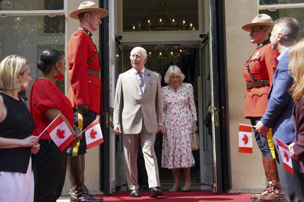Britain's King Charles, centre left, and Queen Camilla leave after visiting the Canada House Trafalgar Square, in London, Tuesday, May 20, 2025 to mark 100 years since it opened in June 1925. (Arthur Edwards/Pool via AP)