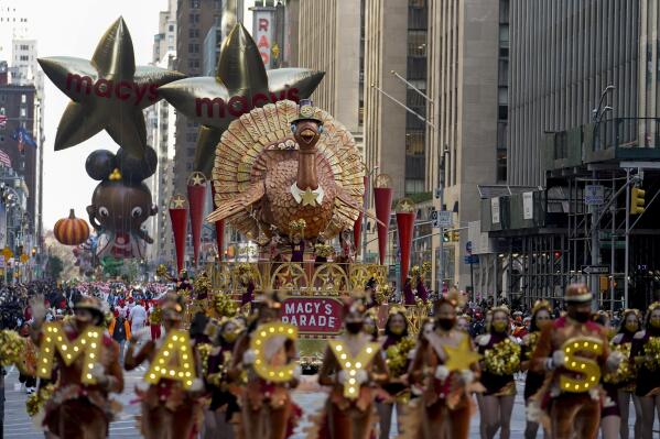 The Tom Turkey float moves down Sixth Avenue during the Macy's Thanksgiving Day Parade in New York, Thursday, Nov. 25, 2021. The parade is returning in full, after being crimped by the coronavirus pandemic last year.  (AP Photo/Jeenah Moon)