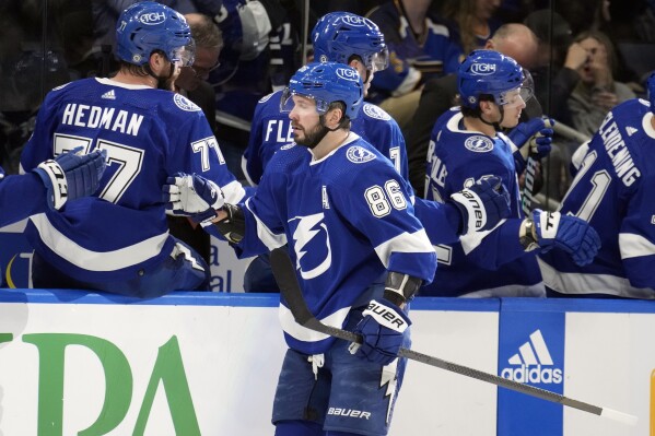 Tampa Bay Lightning right wing Nikita Kucherov (86) celebrates with the bench after his goal against the St. Louis Blues during the first period of an NHL hockey game Tuesday, Dec. 19, 2023, in Tampa, Fla. (AP Photo/Chris O'Meara)