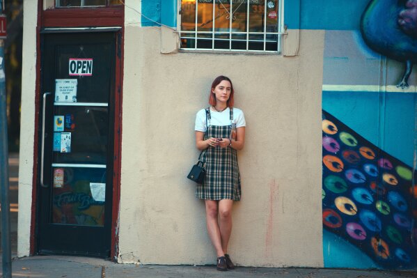 
              This image released by A24 Films shows Saoirse Ronan in a scene from "Lady Bird." The film, which won a Golden Globe Award for best motion picture comedy, is a contender for an Oscar for best picture. (Merie Wallace/A24 via AP)
            
