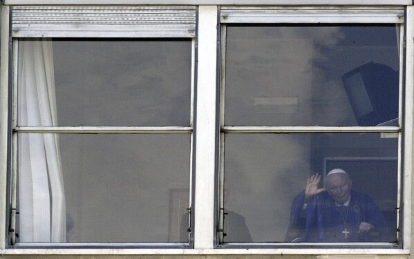Pope John Paul II waves from a window of his rooms on the 10th floor of Rome's Gemelli Polyclinic Hospital, Wednesday, March 9, 2005. (AP Photo/Rudi Blaha, File)