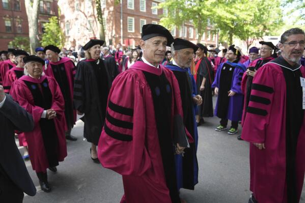 Actor Tom Hanks, center, walks in a procession though Harvard Yard at the start of Harvard University commencement exercises, Thursday, May 25, 2023, on the school's campus, in Cambridge, Mass. (AP Photo/Steven Senne)