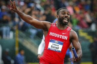 FILE - In this June 8, 2018 file photo, Houston's Cameron Burrell raises two fingers to indicate Houston's back-to-back men's 400-meter relay wins, during the third day of the NCAA Outdoor Track and Field Championships at Hayward Field in Eugene, Ore.   Burrell, the former NCAA national champion sprinter died on Monday, Aug. 9, 2021 according to the University of Houston, where he starred from 2013-2018. (Andy Nelson/The Register-Guard via AP, File)