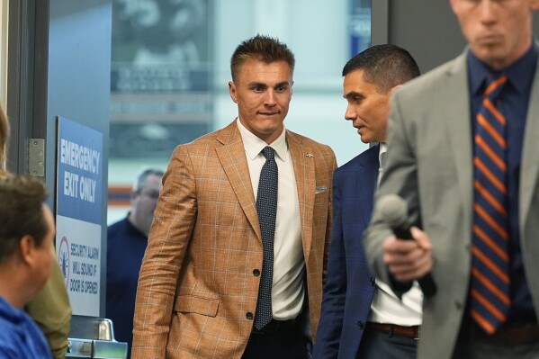 Quarterback Bo Nix arrives for an NFL football news conference Friday, April 26, 2024, with the Denver Broncos in Centennial, Colo. (AP Photo/David Zalubowski)