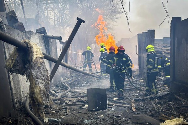 In this photo provided by the Ukrainian Emergency Service, emergency services work at the scene of a Russian attack in Odesa, Ukraine, Friday, March 15, 2024. A Russian missile strike on Odesa in southern Ukraine on Friday killed at least 14 people and injured 46 others, local officials said. A first missile struck houses and when emergency crews arrived at the scene a second missile landed, authorities said. (Ukrainian Emergency Service via AP Photo)