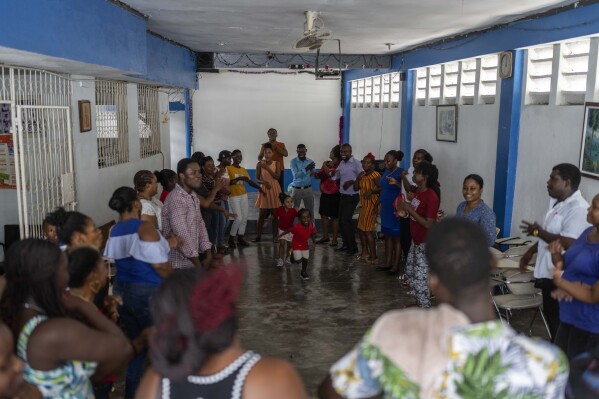 Parents attend training to learn how to help their children overcome trauma and fear amid persistent gang violence, in Port-au-Prince, Haiti, Sunday, May 5, 2024. As young Haitians are increasingly exposed to violence, the country is undergoing a wider push to dispel a long-standing taboo on seeking therapy and talking about mental health. (AP Photo/Ramon Espinosa)