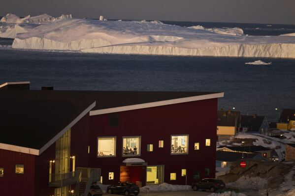 Public school pupils are seen inside their classrooms next to the large icebergs in the city of Ilulissat, Greenland, Feb. 19, 2025. (AP Photo/Emilio Morenatti)
