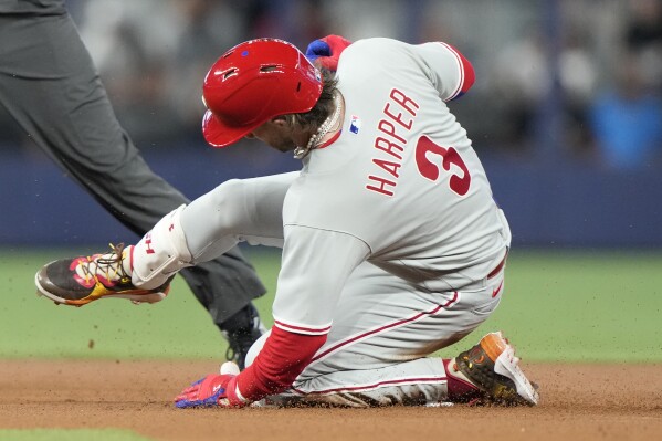 Philadelphia Phillies' Bryce Harper (3) is safe at second with a double during the first inning of a baseball game against the Miami Marlins, Saturday, July 8, 2023, in Miami. (AP Photo/Lynne Sladky)