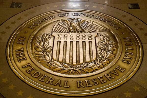FILE- In this Feb. 5, 2018, file photo, the seal of the Board of Governors of the United States Federal Reserve System is displayed in the ground at the Marriner S. Eccles Federal Reserve Board Building in Washington. (AP Photo/Andrew Harnik, File)