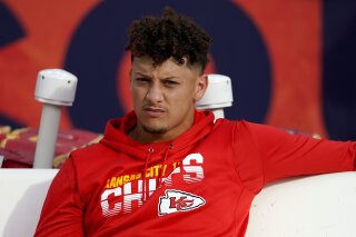 FILE - In this Thursday, Oct. 17, 2019, file photo, Kansas City Chiefs quarterback Patrick Mahomes sits on the bench prior to an NFL football game against the Denver Broncos in Denver. The Chiefs have ruled Mahomes out for Sunday night's showdown against the Green Bay Packers because of his dislocated right kneecap. Mahomes, who hurt his knee last Thursday night in Denver, was a limited participant in practice all week. (AP Photo/Jack Dempsey, File)