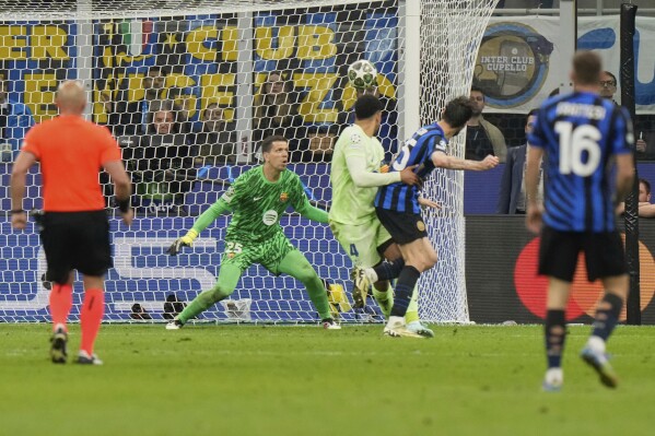 Inter Milan's Francesco Acerbi, second right, scores his side's third goal during the Champions League semifinal second leg soccer match between Inter Milan and Barcelona at San Siro stadium in Milan , Italy, Tuesday, May 6, 2025. (AP Photo/Luca Bruno)