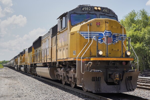 FILE - A Union Pacific train travels through Union, Neb., July 31, 2018. Union Pacific's third-quarter profit fell 19% as the railroad hauled fewer shipments and costs remained high, but the average speed of its trains improved 5% as new CEO Jim Vena began to tweak the operations, the company reported Thursday, Oct. 19, 2023. (AP Photo/Nati Harnik, File)