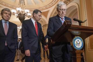 Senate Minority Leader Mitch McConnell of Ky., right, arrives to attends a news conference with Sen. Roy Blunt, R-Mo., far left, and Sen. John Barrasso, R-Wyo., Tuesday, March 1, 2022, at the Capitol in Washington. (AP Photo/Jacquelyn Martin)