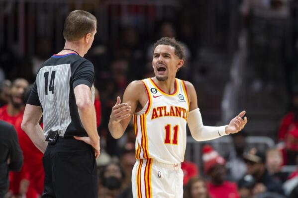 Atlanta Hawks guard Trae Young (11) yells at referee Ed Malloy (14) during the second half of an NBA basketball game against the Chicago Bulls, Sunday, Dec. 11, 2022, in Atlanta. (AP Photo/Hakim Wright Sr.)
