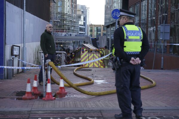 The scene at the Station Hill development site in Reading where a fire broke out trapping a workman on the roof in Reading, England, Thursday Nov. 23, 2023. A crane operator played down tributes paid to him on Thursday after he lifted a man to safety from a burning high-rise building in England. (Lucy North/PA via AP)