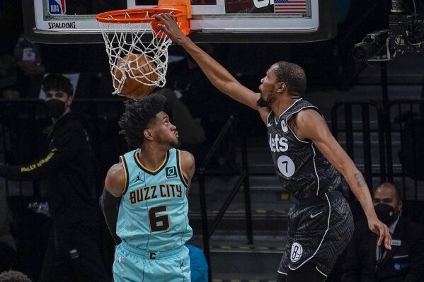 Brooklyn Nets forward Kevin Durant (7) goes to the basket past Charlotte Hornets forward Jalen McDaniels (6) during the second half of an NBA basketball game Friday, April 16, 2021, in New York. (A...
