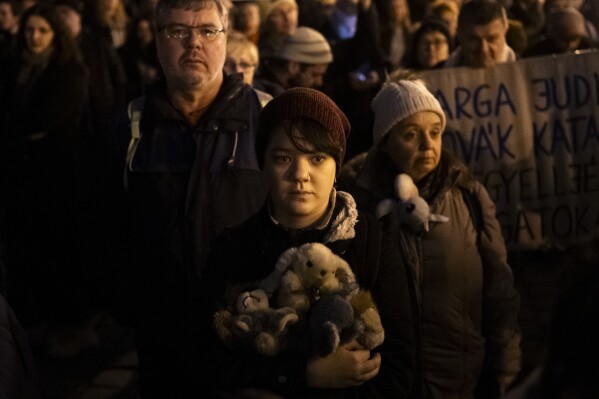 People attend a protest after Hungarian president Katalin Novák issued a pardon in a child sexual abuse case in Budapest, Hungary, Feb. 9, 2024. Pressure is mounting on Hungary's head of state to resign after it was revealed that she issued a presidential pardon to a man convicted as an accomplice in a child sexual abuse case. (AP Photo/Denes Erdos)