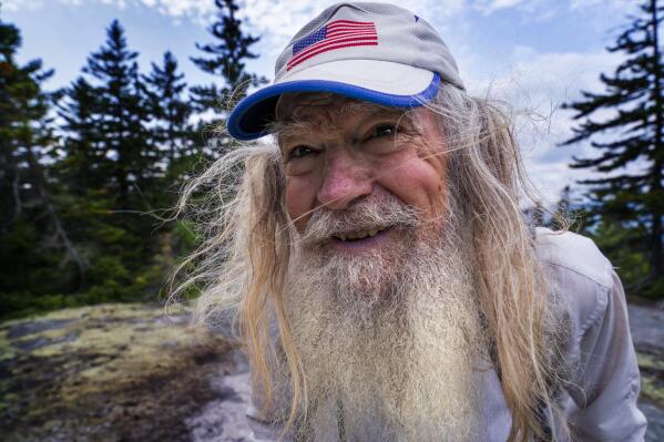 M.J. Eberhart, 83, arrives on the summit of Mount Hayes on the Appalachian Trail, Sunday, Sept. 12, 2021, in Gorham, New Hampshire. Eberhart, who goes by the trail name of Nimblewill Nomad, is the oldest person to hike the entire 2,193-mile Appalachian Trail. (AP Photo/Robert F. Bukaty)