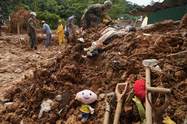 Children's toys lay in the mud where rescue workers look for bodies after a deadly landslide was triggered by heavy rains near Barra do Sahi beach in the coastal city of Sao Sebastiao, Brazil, Wednesday, Feb. 22, 2023. (AP Photo/Andre Penner)