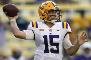 FILE - LSU quarterback Myles Brennan passes in the second half an NCAA college football game against Mississippi State in Baton Rouge, La., Sept. 26, 2020. Brennan has decided to exit the transfer portal and return to LSU under new head coach Brian Kelly. (AP Photo/Gerald Herbert, File)
