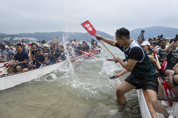 Competitors cheer and celebrate after the race in the Stanley International Dragon Boat Championships to celebrate the Dragon Boat Festival in Hong Kong, Saturday, May 31, 2025. (AP Photo/Chan Long Hei)
