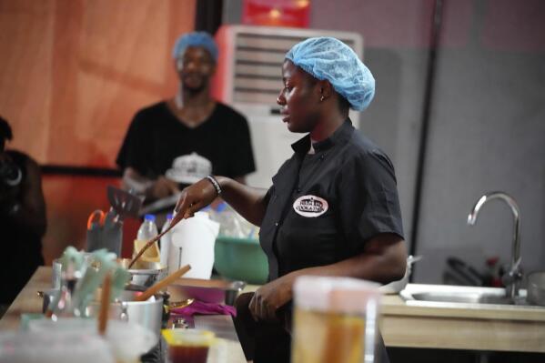 Chef Hilda Baci cooks to establish a new Guinness world record for the "longest cooking marathon", the 97-hour cook-a-thon, in Lagos, Nigeria, Thursday, May 11, 2023. A Nigerian chef on Monday continued her quest to set a new global record for the longest hours of nonstop cooking after surpassing the current record of 87 hours and 45 minutes. By 15:00 GMT on Monday, Hilda Baci had cooked for more than 97 hours, becoming a national sensation and to the cheering of many in Nigeria's commercial hub of Lagos where her kitchen is set. (AP Photo/Sunday Alamba)