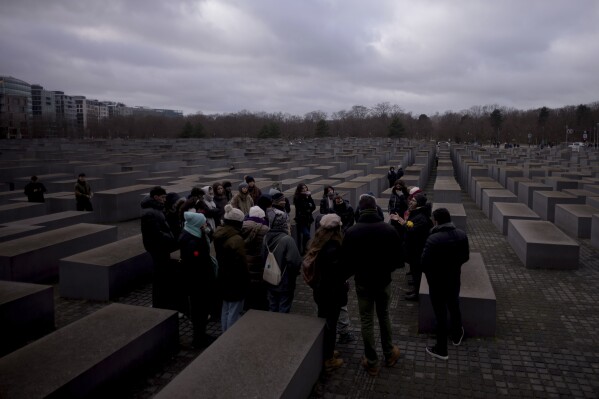 FILE - Tourists visit the Holocaust Memorial in Berlin, Germany, on International Holocaust Remembrance Day, on Jan. 27, 2024. More than 250 Holocaust survivors have joined an international initiative to share their stories of loss and survival with students around the world during a time of rising antisemitism following the Oct. 7 Hamas attack on Israel that triggered the war in the Gaza Strip. The Survivor Speakers Bureau was launched Thursday by the New York-based Conference on Jewish Material Claims Against Germany, also referred to as the Claims Conference. (AP Photo/Markus Schreiber, File)
