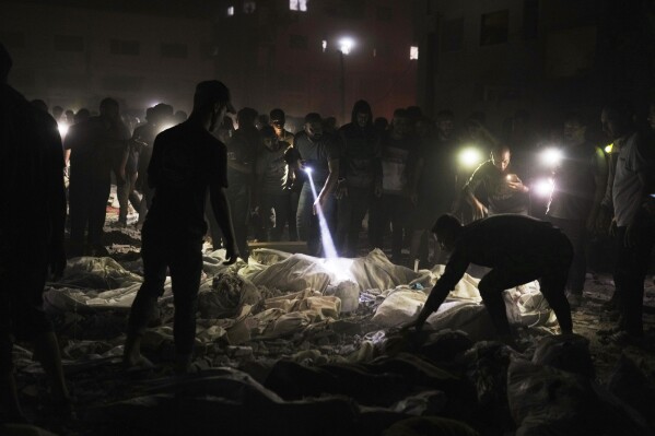 Palestinians inspect a site used as a shelter for displaced residents that was hit by Israeli military strike, in Gaza City, on Sunday, May 25, 2025. (AP Photo/Jehad Alshrafi)