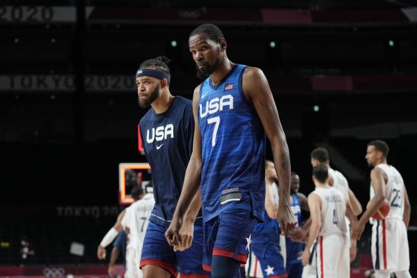 United States' Javale Mc Gee, left, and forward Kevin Durant (7) walk off the court after their loss to France in a men's basketball preliminary round game at the 2020 Summer Olympics, Sunday, July 25, 2021, in Saitama, Japan. (AP Photo/Eric Gay)