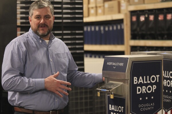 FILE - Douglas County, Kan., Clerk Jamie Shew discusses the operations of voting drop boxes while giving a tour of his office's warehouse in Lawrence, Kan., March 21, 2022. In the wake of a Kansas Supreme Court ruling that finds voting is not a fundamental right under the state's Bill of Rights, Shew says constant changes in election law are confusing not only to election officials, but to voters. (AP Photo/John Hanna, File)