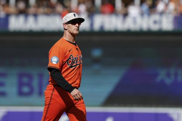 Baltimore Orioles interim manager Tony Mansolino walks off the field after removing pitcher Kyle Gibson during the first inning of a baseball game against the Washington Nationals in Baltimore, Saturday, May 17, 2025. (AP Photo/Terrance Williams)