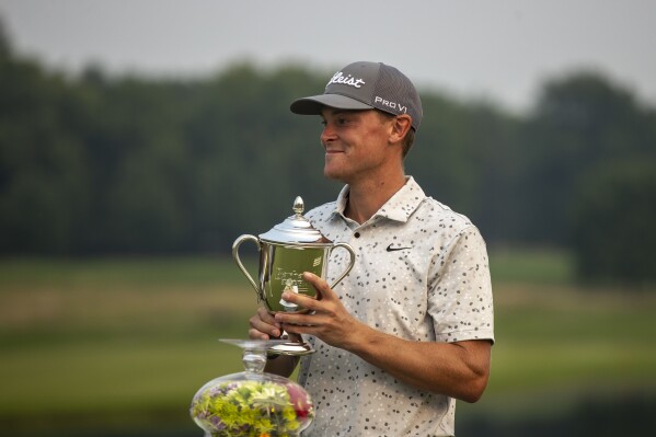 Vincent Norrman holds a trophy after winning the Barbasol Championship golf tournament at Keen Trace Gold Club in Nicholasville, Ky., on Sunday, July 16, 2023. (Ryan C. Hermens/Lexington Herald-Leader via AP)