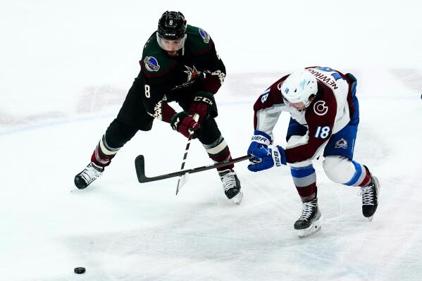 Colorado Avalanche center Alex Newhook (18) battles with Arizona Coyotes center Nick Schmaltz (8) for the puck during the first period of an NHL hockey game Thursday, March 3, 2022, in Glendale, Ariz. (AP Photo/Ross D. Franklin)