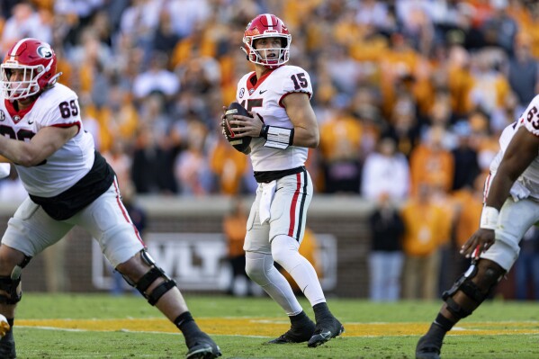 Georgia quarterback Carson Beck (15) looks for a receiver during the first half of an NCAA college football game against Tennessee, Saturday, Nov. 18, 2023, in Knoxville, Tenn. (AP Photo/Wade Payne)