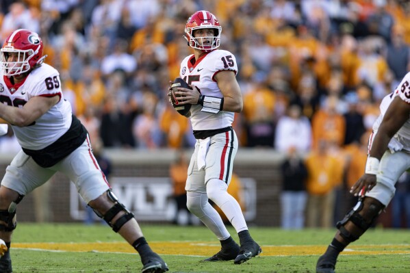 Georgia quarterback Carson Beck (15) looks for a receiver during the first half of an NCAA college football game against Tennessee, Saturday, Nov. 18, 2023, in Knoxville, Tenn. (AP Photo/Wade Payne)
